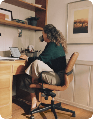 Person working on a laptop at a home desk