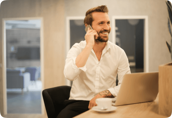 Man taking a business call at a laptop